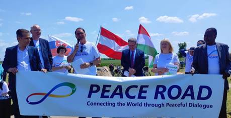 Ist möglicherweise ein Bild von 11 Personen, Straße und Text „PEACE Aqu adojna PEACE ROAD Connecting the World through Peaceful Dialogue“
